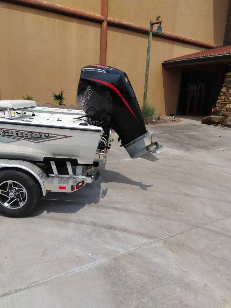 Slide: The Image of Ranger RB210 boat on trailer, 2025 model, parked on concrete driveway. - 3