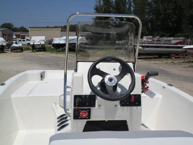 Slide: The Image of 2023 Mako Pro Skiff 17 CC boat console with steering wheel and controls. - 3