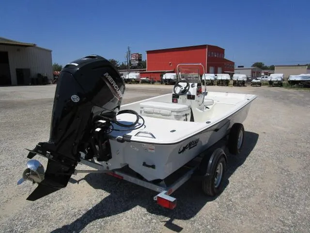 Slide: The Image of 2023 Mako Pro Skiff 17 CC boat on trailer, featuring a powerful outboard motor. - 4