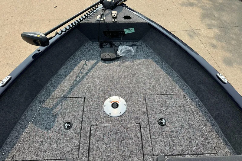 Slide: The Image of 2025 Tracker Pro Guide V-175 WT boat interior with carpeted deck and storage compartments. - 4