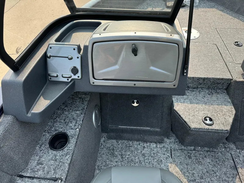 Slide: The Image of 2025 Tracker Pro Guide V-175 WT boat interior with storage compartments and carpeted flooring. - 5