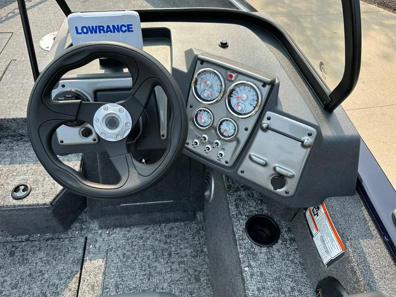 Slide: The Image of 2025 Tracker Pro Guide V-175 WT boat dashboard with steering wheel and instrument panel. - 6