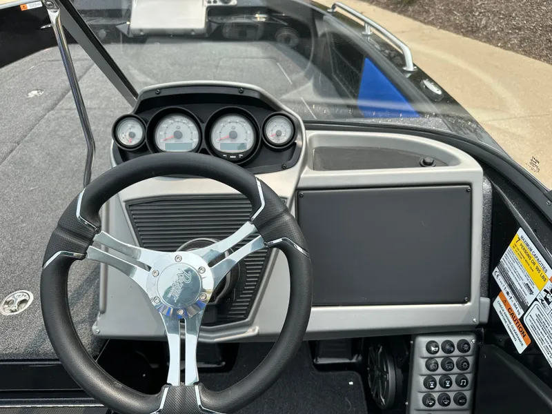 Slide: The Image of 2025 Ranger 2080MS boat dashboard with steering wheel and instrument panel. - 11