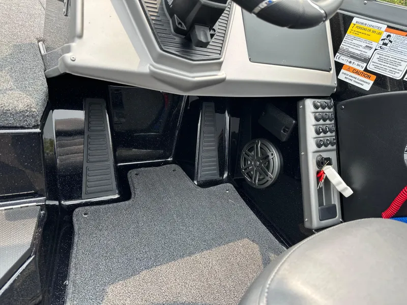 Slide: The Image of Interior view of 2025 Ranger 2080MS boat cockpit with pedals and control panel. - 13