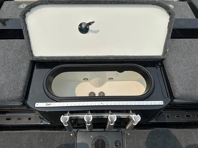 Slide: The Image of 2025 Ranger 2080MS boat livewell with measuring ruler and rod holders. - 18