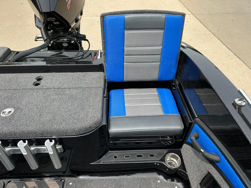 Slide: The Image of 2025 Ranger 2080MS boat seat with blue and gray upholstery, featuring rod holders and storage. - 19