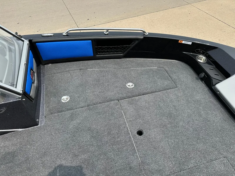 Slide: The Image of 2025 Ranger 2080MS boat deck with gray carpet and blue accents. - 5