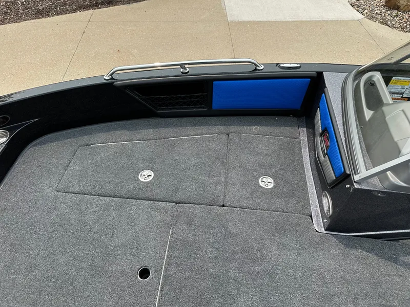 Slide: The Image of 2025 Ranger 2080MS boat interior with gray carpet and blue accents. - 6