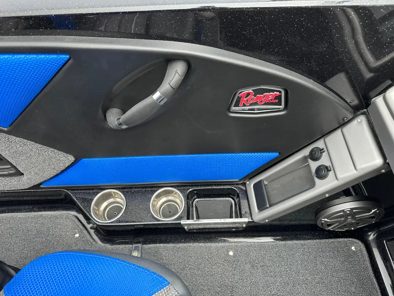 Slide: The Image of Interior of 2025 Ranger 2080MS boat with blue accents and cup holders. - 7