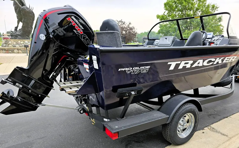 Slide: The Image of 2025 Tracker Pro Guide V-175 Combo boat on trailer, featuring powerful outboard motor. - 4