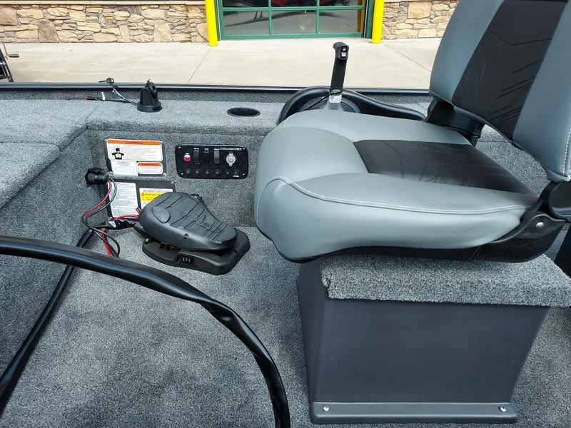 Slide: The Image of 2025 Tracker Panfish 17 boat interior with gray seating and control panel. - 3