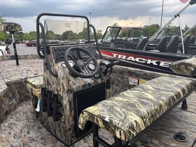 Slide: The Image of 2025 Ranger RB200 boat with camouflage design, featuring steering console and seating. - 2