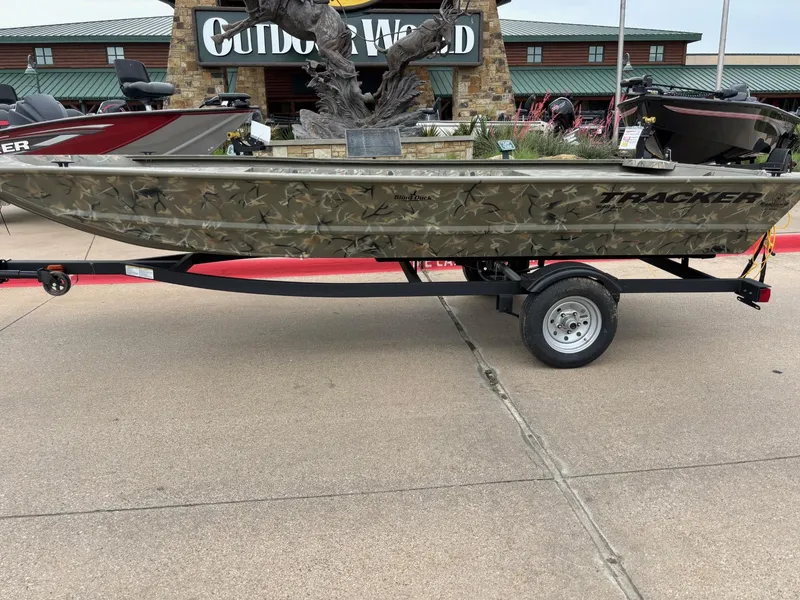 Slide: The Image of 2025 Tracker Grizzly 1648 Jon boat on trailer outside Outdoor World. - 2