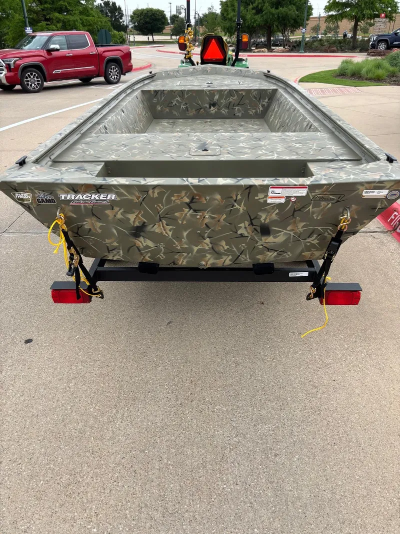 Slide: The Image of 2025 Tracker Grizzly 1648 Jon boat on trailer, parked outdoors. - 3