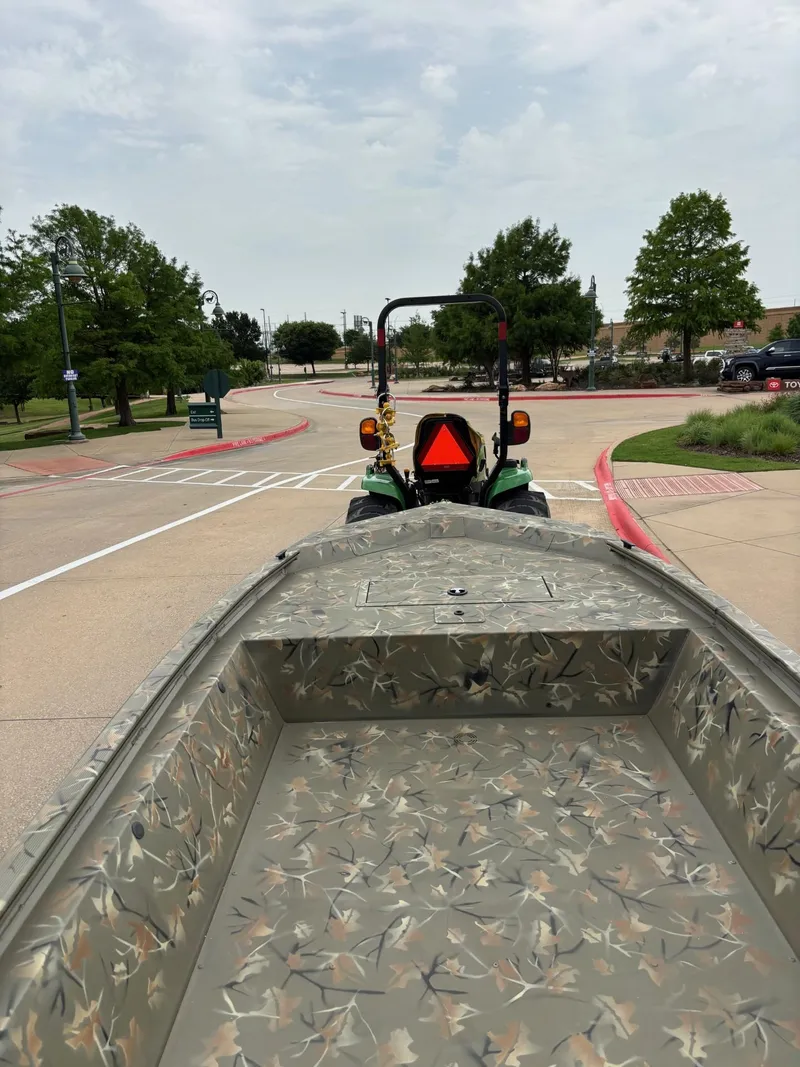 Slide: The Image of 2025 Tracker Grizzly 1648 Jon boat on trailer in parking lot. - 4