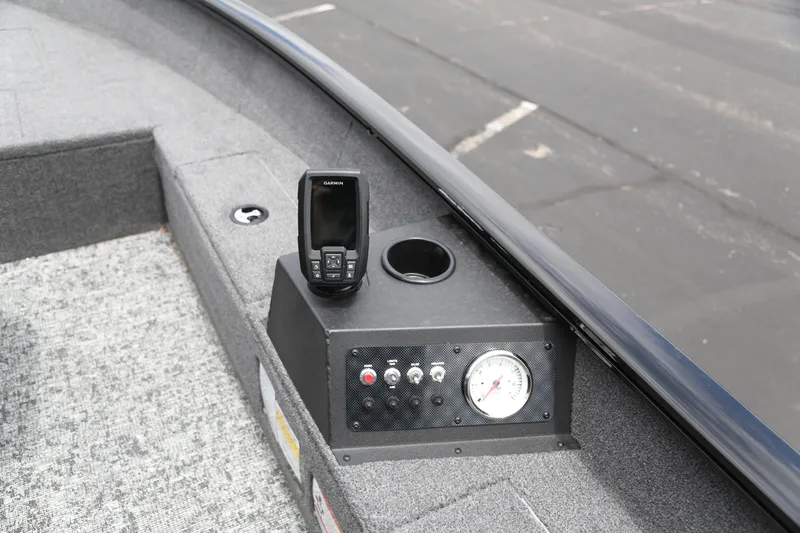Slide: The Image of 2025 Tracker Super Guide V-16 T boat dashboard with controls and fish finder. - 3
