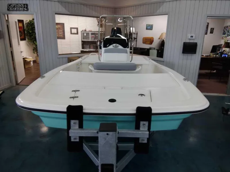 Slide: The Image of 2024 Mako Pro Skiff 13 CC boat displayed indoors on a trailer. - 3