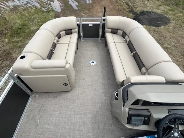 Slide: The Image of 2025 Sun Tracker Party Barge 22 DLX interior with beige seating and steering console. - 10