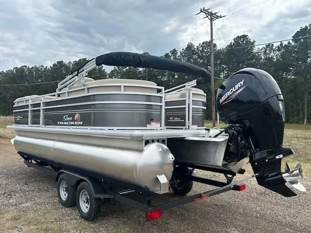 Slide: The Image of 2025 Sun Tracker Party Barge 22 DLX pontoon boat with Mercury engine on trailer. - 12