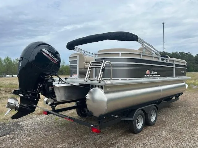 Slide: The Image of 2025 Sun Tracker Party Barge 22 DLX pontoon boat with Mercury outboard motor on trailer. - 14