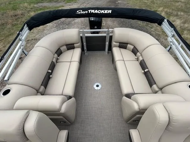 Slide: The Image of 2025 Sun Tracker Party Barge 22 DLX with beige seating and spacious layout. - 7