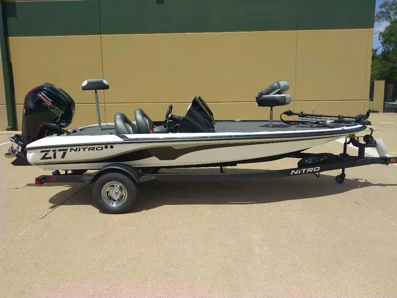 Slide: The Image of 2025 Nitro Z17 fishing boat on trailer, parked outdoors. - 1