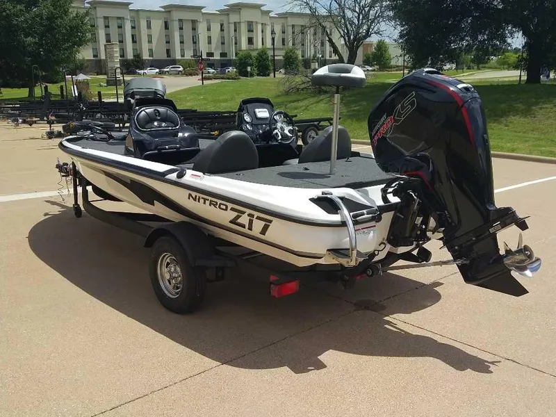 Slide: The Image of 2025 Nitro Z17 boat with powerful outboard motor, parked outdoors on a sunny day. - 11