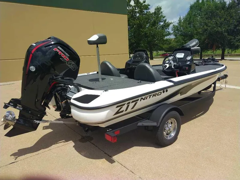 Slide: The Image of 2025 Nitro Z17 boat with Mercury engine, parked on a trailer, outdoors. - 2