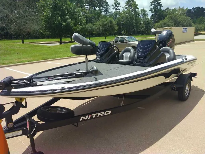 Slide: The Image of 2025 Nitro Z17 boat on trailer in parking lot, surrounded by trees. - 7