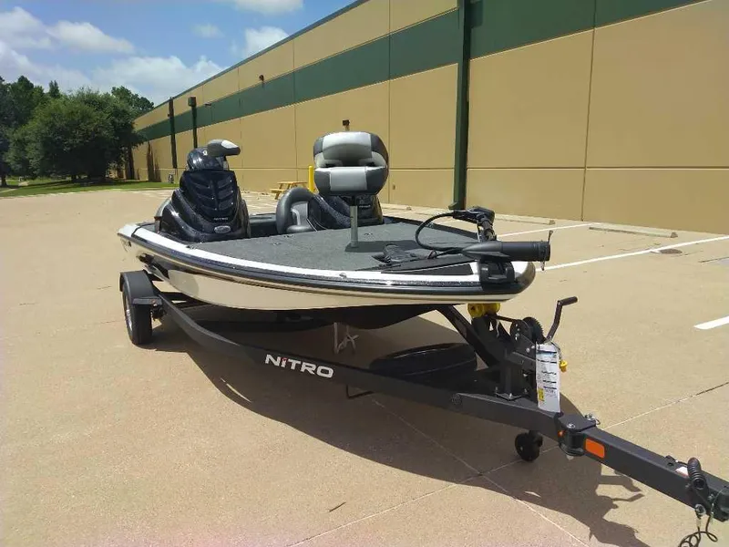 Slide: The Image of 2025 Nitro Z17 boat on trailer in parking lot, sunny day. - 8