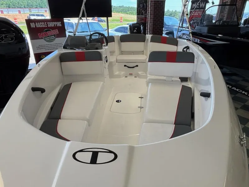Slide: The Image of 2025 Tahoe T16 boat interior with white and gray seating, displayed indoors. - 2