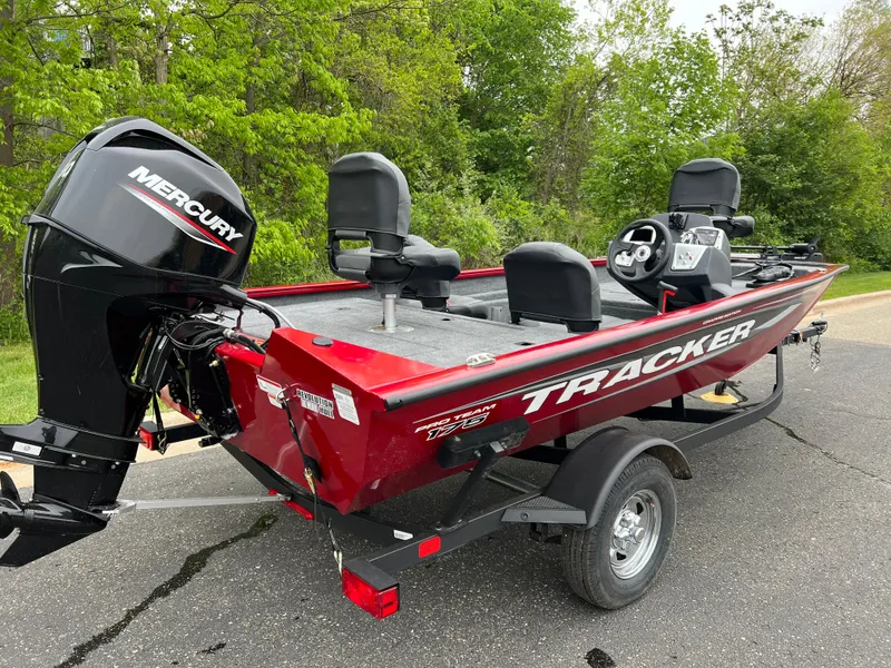 Slide: The Image of 2025 Tracker Pro Team 175 Crappie Edition boat with Mercury engine on a trailer. - 2