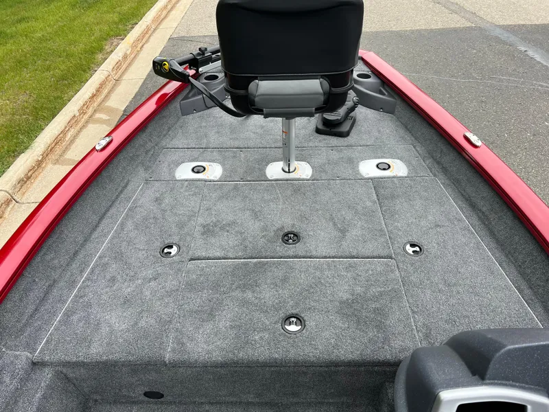 Slide: The Image of 2025 Tracker Pro Team 175 Crappie Edition boat with gray carpeted deck and swivel seat. - 5