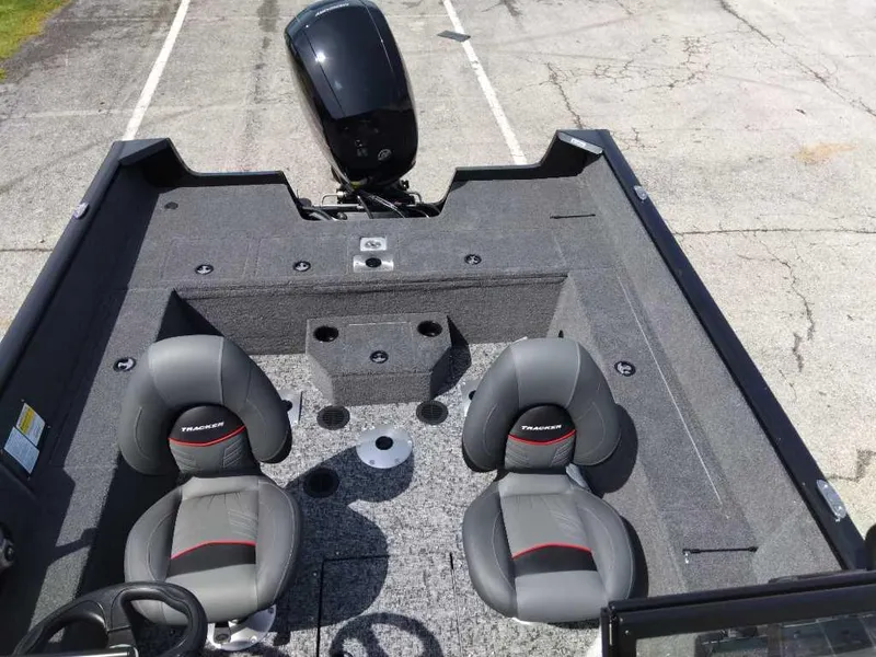 Slide: The Image of 2024 Tracker Pro Guide V-175 WT boat interior with dual seats and motor. - 11