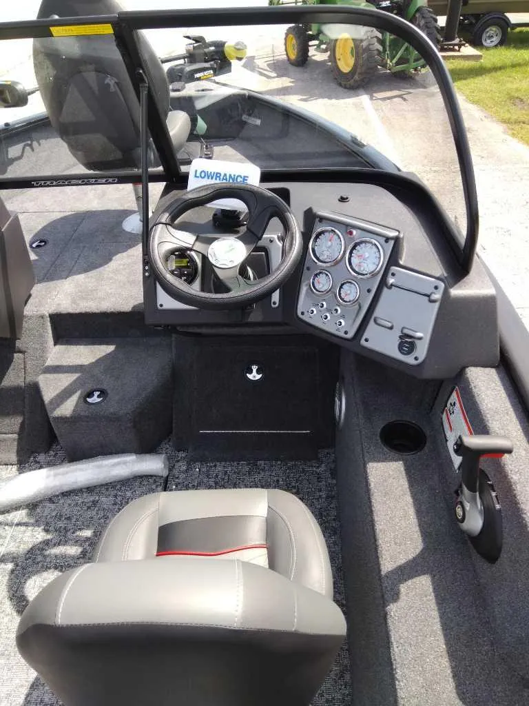 Slide: The Image of 2024 Tracker Pro Guide V-175 WT boat interior with steering wheel and control panel. - 5