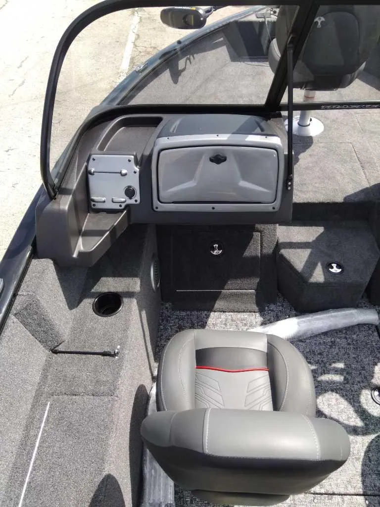 Slide: The Image of 2024 Tracker Pro Guide V-175 WT boat interior with gray seating and dashboard. - 6