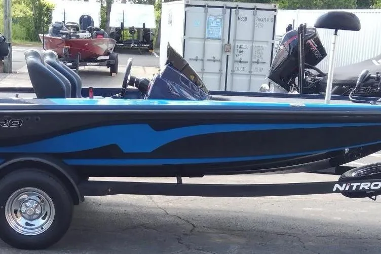 Slide: The Image of 2025 Nitro Z18 boat with blue and black design on a trailer. - 0