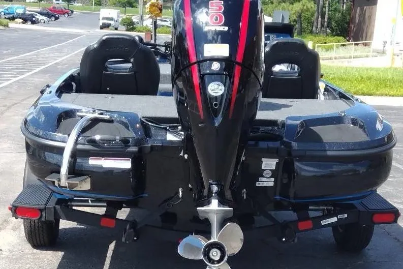 Slide: The Image of 2025 Nitro Z18 boat with powerful outboard motor, parked in a sunny lot. - 6