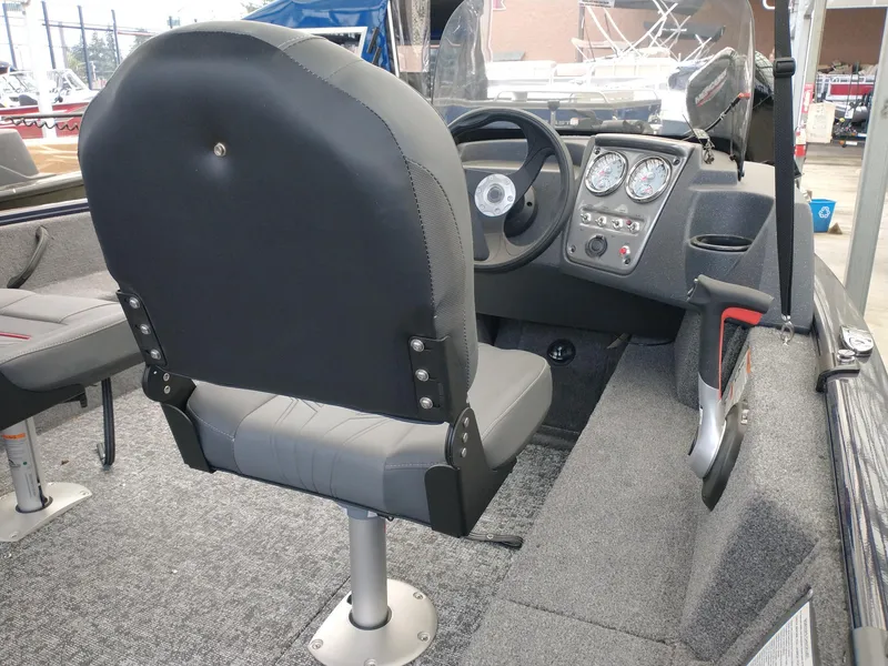 Slide: The Image of 2025 Tracker Pro Guide V-16 SC boat interior with steering wheel and dashboard controls. - 2