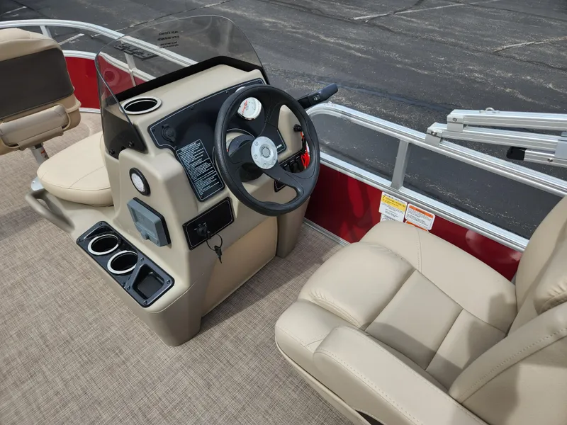 Slide: The Image of 2025 Sun Tracker Bass Buggy 16 XL Select boat interior with steering console and seating. - 3
