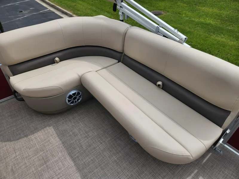 Slide: The Image of 2025 Sun Tracker Bass Buggy 16 XL Select pontoon boat seating, beige upholstery, outdoor setting. - 4