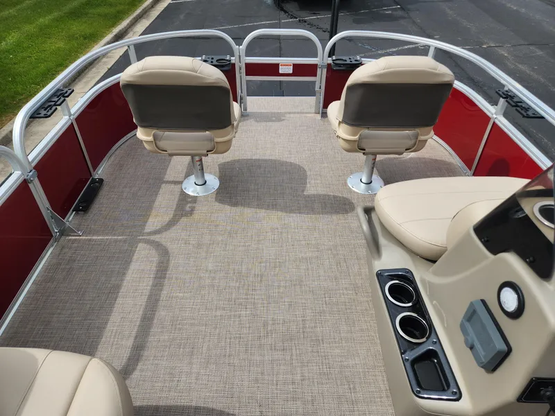 Slide: The Image of 2025 Sun Tracker Bass Buggy 16 XL Select pontoon boat interior with beige seating and red accents. - 5