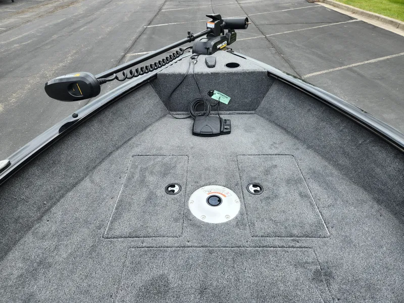 Slide: The Image of 2025 Tracker Super Guide V-16 SC boat deck with trolling motor and carpeted surface. - 3