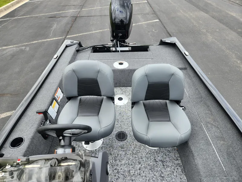 Slide: The Image of 2025 Tracker Super Guide V-16 SC boat interior with dual gray seats and steering console. - 4