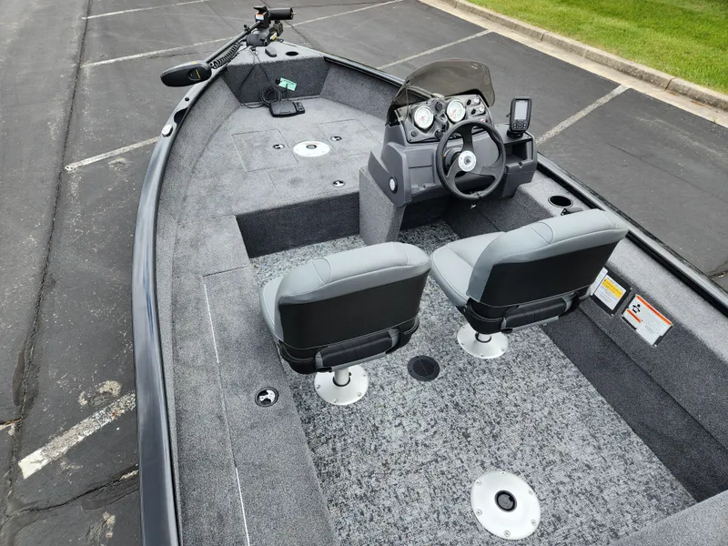 Slide: The Image of 2025 Tracker Super Guide V-16 SC boat interior with dual seats and steering console. - 5