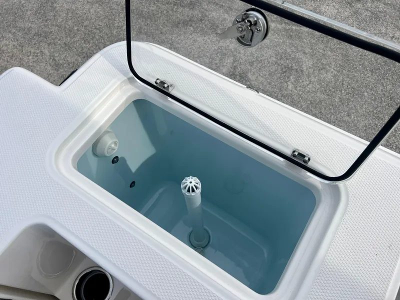 Slide: The Image of Livewell compartment on 2025 Robalo R300 boat, open lid, white interior. - 20