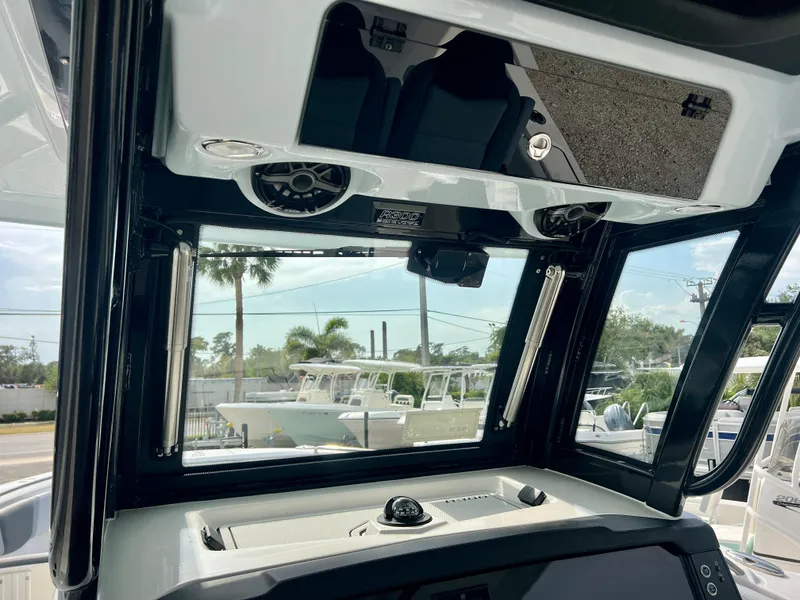 Slide: The Image of Interior view of 2025 Robalo R300 boat cockpit with modern controls and speakers. - 25