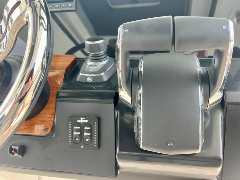 Slide: The Image of Control panel of 2025 Robalo R300 boat with steering wheel and throttle. - 26