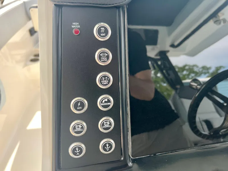 Slide: The Image of Control panel of 2025 Robalo R300 boat with various function buttons. - 27