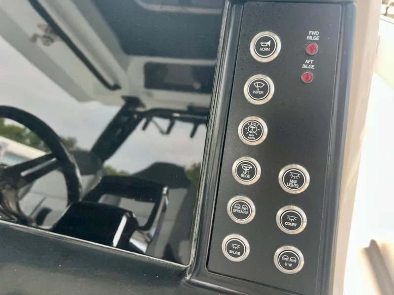 Slide: The Image of Control panel of 2025 Robalo R300 boat with various function buttons. - 28